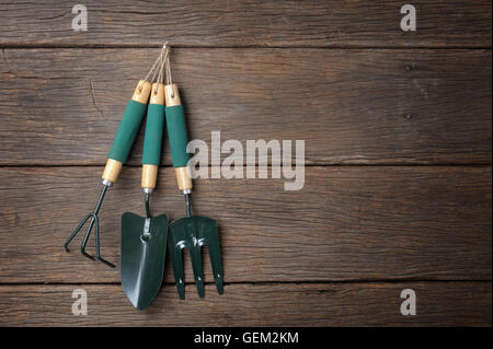 gardening tools hanging on wooden plank background Stock Photo