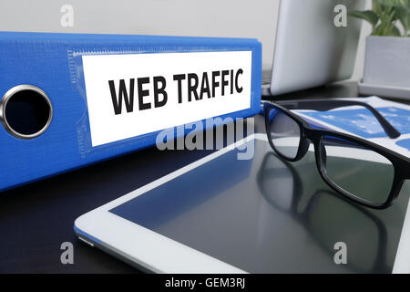 WEB TRAFFIC Office folder on Desktop on table with Office Supplies. ipad Stock Photo