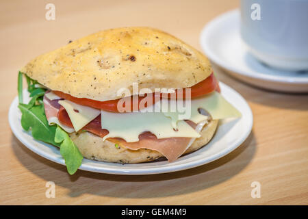 Breakfast ham, cheese and tomato bun on a plate Stock Photo