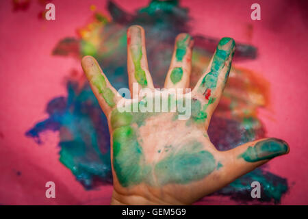 Child's hand with colored fingers from using paint Stock Photo