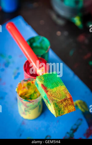 Empty green red and yellow plant tube on a table in childrens room Stock Photo