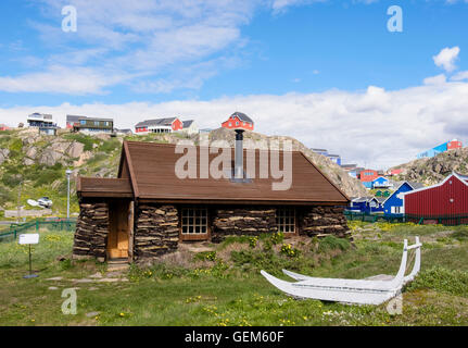 Reconstructed early 20th century Greenlandic Turf House with traditional sledge in the museum. Sisimiut Qeqqata West Greenland Stock Photo