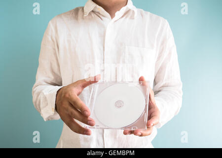 Man holding DVD-ROM Stock Photo