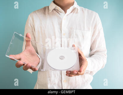 Man holding DVD-ROM Stock Photo