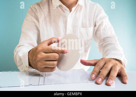 Man holding DVD-ROM Stock Photo