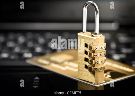 Data security concept with padlock on laptop computer keyboard and credit card Stock Photo