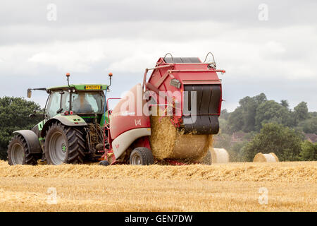 Deutz-Fahr tractor and Lely  Welger RP435 Baler working near Ecton, Northamptonshire. Stock Photo