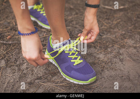 Runner woman tying shoelaces. Tie shoelaces. sport, fitness, exercise and lifestyle Stock Photo