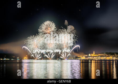 Fireworks on the lakefront of Arona in a summer party night seen from Angera, Major Lake- Piedmont Stock Photo