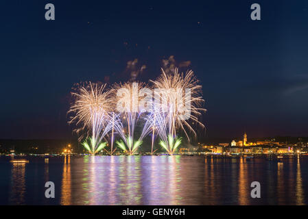Fireworks on the lakefront of Arona in a summer party night seen from Angera, Major Lake- Piedmont Stock Photo