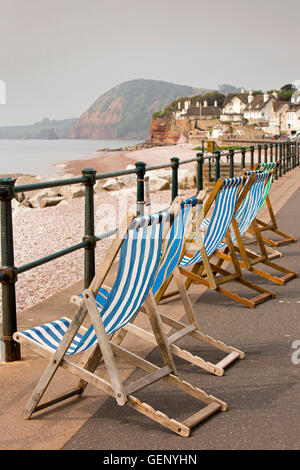 UK, England, Devon, Sidmouth, The Esplanade, colourful deckchairs on seafront above shingle beach Stock Photo