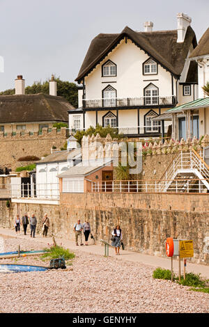 UK, England, Devon, Sidmouth, visitors on Clifton Walkway below thatched seafront houses on Peak Hill Road Stock Photo