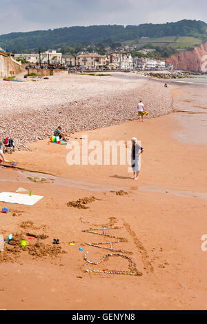 UK, England, Devon, Sidmouth, Clifton Beach, name Isaac created in pebbles on sand Stock Photo