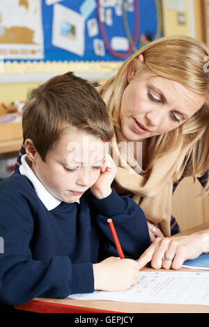 Male Elementary School Pupil Struggling In Class Stock Photo - Alamy