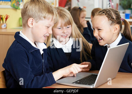 Group Of Elementary School Children Working Together In Computer Class Stock Photo