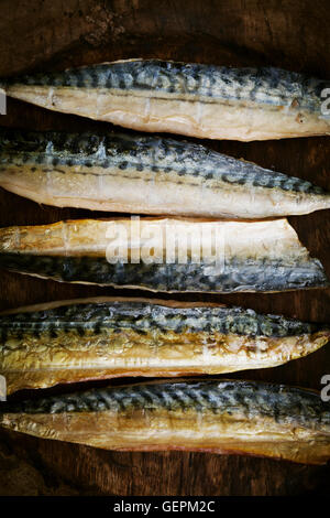 Smoked fish fillets laid out in a row. Stock Photo