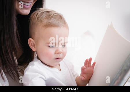 A heavily pregnant woman playing with her young son. Stock Photo