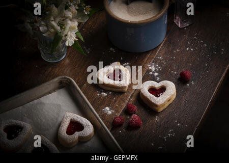 Valentine's Day baking, high angle view of a baking tray with heart shaped biscuits. Stock Photo