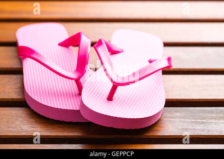 Pink flip flops on wooden floor. Stock Photo