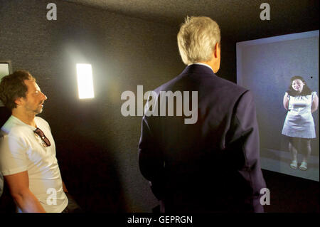 Google Co-Founder Sergey Brin Watches as Secretary Kerry Chats With Rebekah in Seoul Through a Google Portal Interaction at the Global Entrepreneurship Summit in Palo Alto Stock Photo