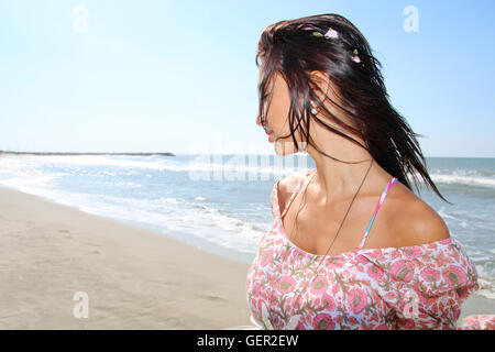 Beautiful woman wearing a garland next to the sea Stock Photo