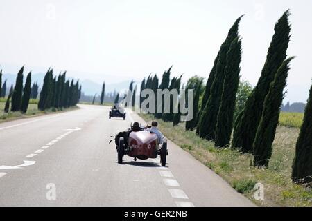 Bugatti speeding down a French road on a windy day during a classic car rally Stock Photo