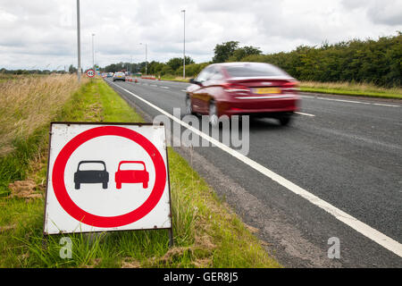 No overtaking signs, road markings, Laws and rules for overtaking in restricted areas; Chapter 8 Traffic Management systems in place on major long-term road works and temporary traffic lights on Preston arterial road, B5253 Flensburg Way in Farington Moss, Lancashire, UK. Stock Photo