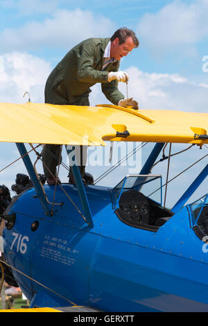 Pilot checks his wing fuel tanks on a Boeing Stearman PT-13 Kaydet vintage biplane built in 1943 as a trainer for the USAAC Stock Photo