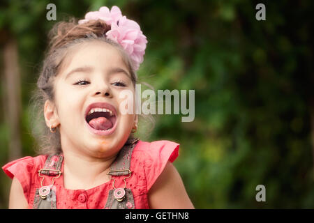 Portrait of girl sticking out tongue Stock Photo