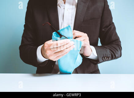 Businessman cleaning glasses Stock Photo