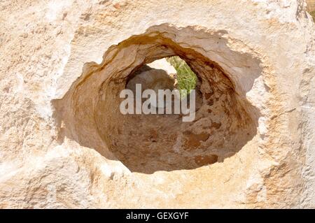 View through a hole in the limestone cliffs at Bir Zekreet Stock Photo ...