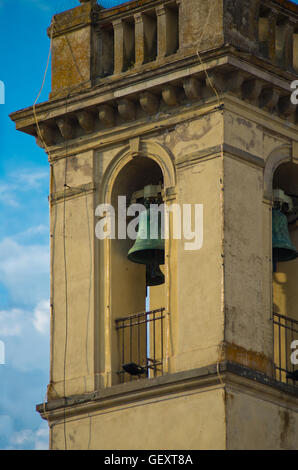 ancient bell tower made of masonry plastered with bronze bells, merlons and decorations Stock Photo
