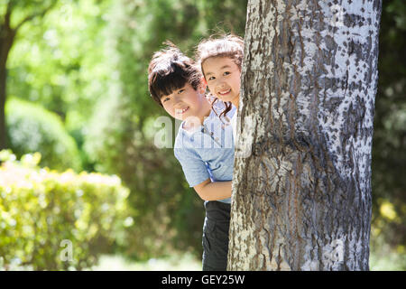 Happy Chinese children playing in woods Stock Photo - Alamy
