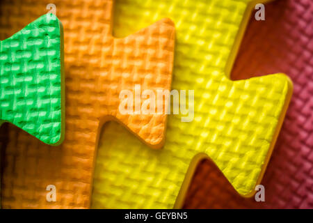 Close up of a joining parts of the colorful pieces of a children's soft toy mat Stock Photo