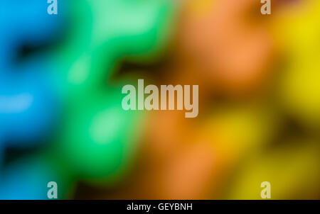 Defocused colorful pieces of a children's soft toy mat, colorful background Stock Photo