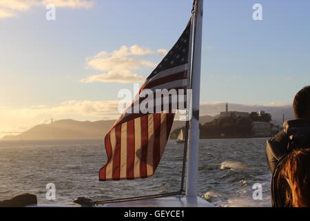 A photograph of the American Flag in beautiful sunlight/sunset on the San Francisco to Sausalito Cruise Stock Photo