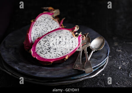 Dragon fruit cut open on a plate Stock Photo
