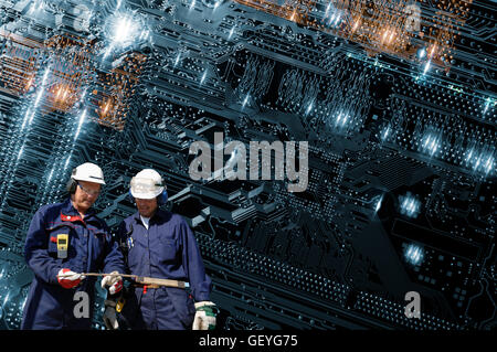 technicians working on giant futuristic circuit-board and microchips Stock Photo