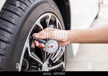 Close-Up Of Hand holding pressure gauge for car tyre pressure ...