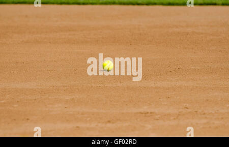 Yellow softball on field Stock Photo