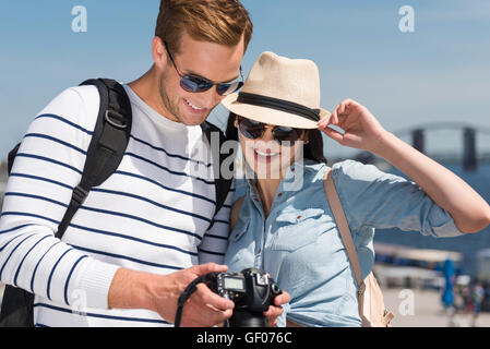 Pleasant smiling couple using photo camera Stock Photo