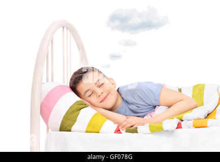 Happy boy sleeping and dreaming sweet dreams with a cloud above his head isolated on white background Stock Photo