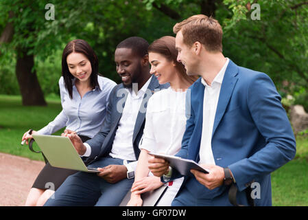 Positive smiling colleagues working outside Stock Photo