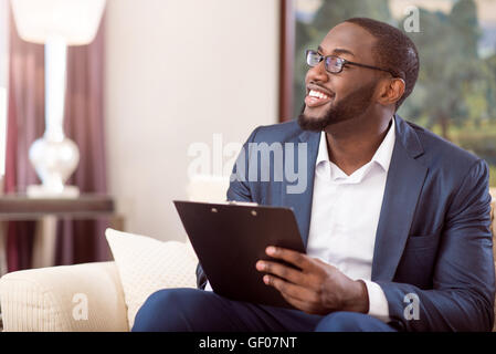 Man in suit noting down information Stock Photo