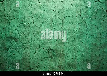 Old texture green cracked wall, the old paint texture is chipping and cracked fall destruction. Grunge wall texture for design. Stock Photo