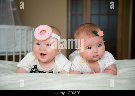 twin baby boy and girl lie on the bed Stock Photo