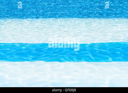 blue and white striped swimming pool background showing cool crystal sun drench water, shot for copy space, backgrounds, texts Stock Photo