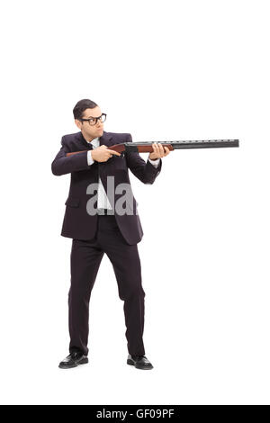 Full length portrait of a young businessman shooting with a rifle isolated on white background Stock Photo