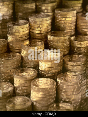 Many pound coins stacked on top of one another, shallow depth of field Stock Photo