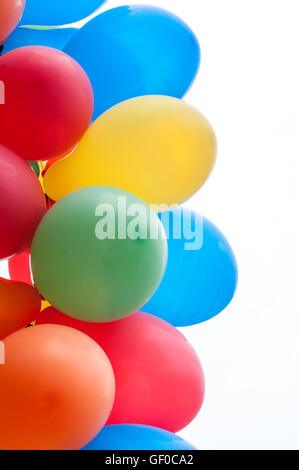 Colored party balloons against white background Stock Photo - Alamy